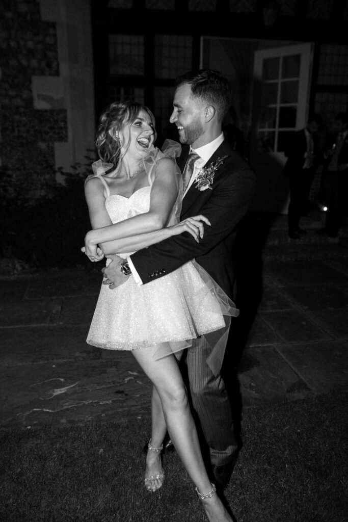 Bride and groom dancing closely together during the evening reception.