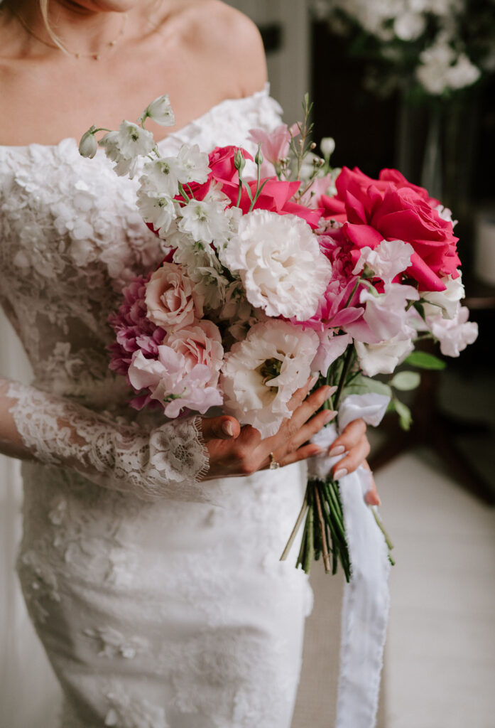 bride holding pink and white rose bouquet at butley priory