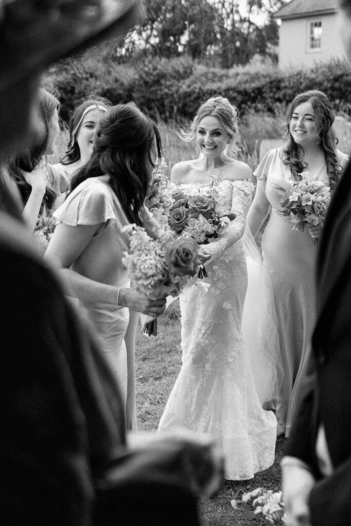 bride having a joyful moment with bridesmaids just before the ceremony