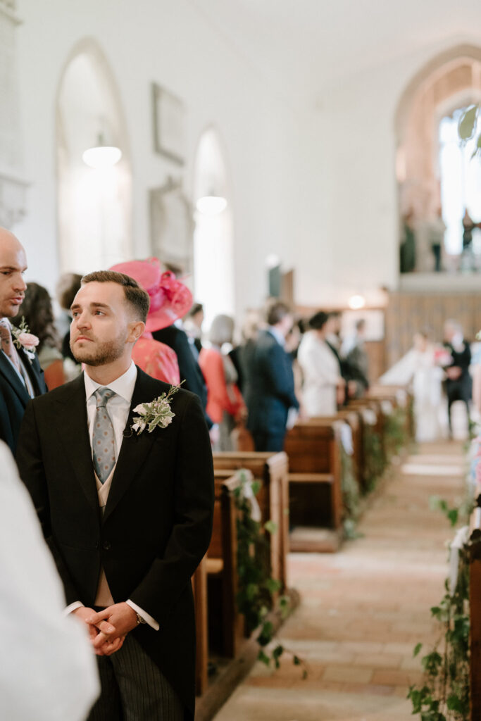 groom waiting at alter of the church just before the bride walks down