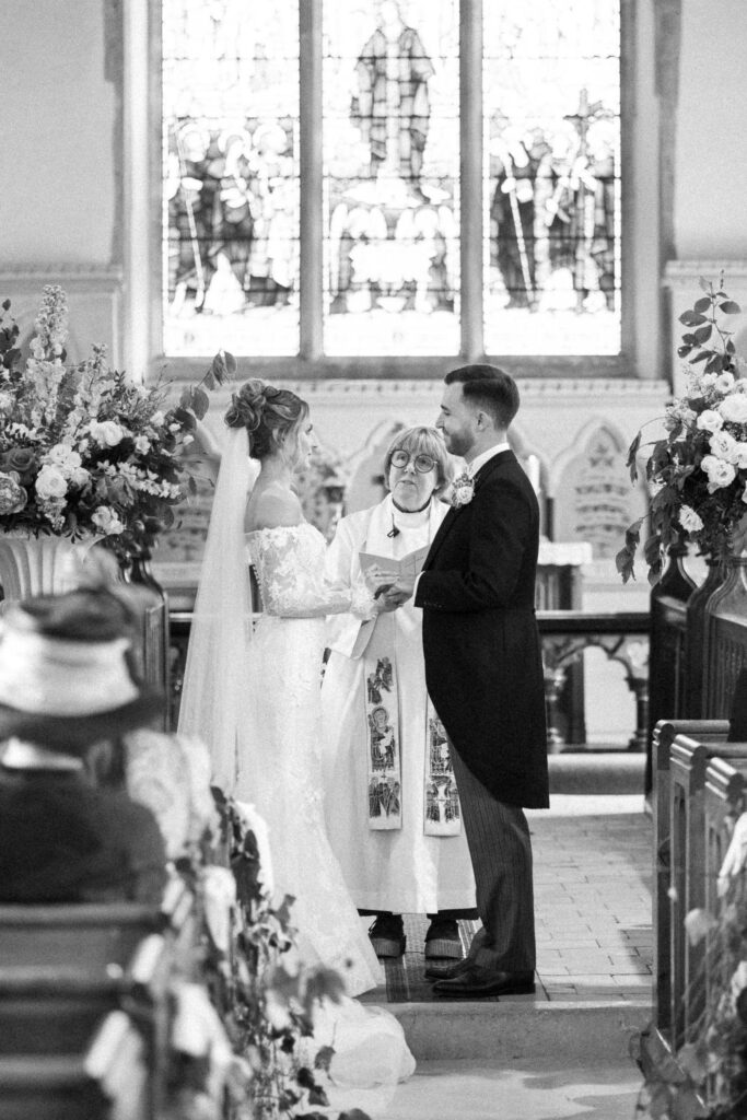 bride and groom standing at alter of church