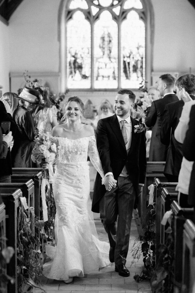 bride and groom walking back down the aisle after getting married