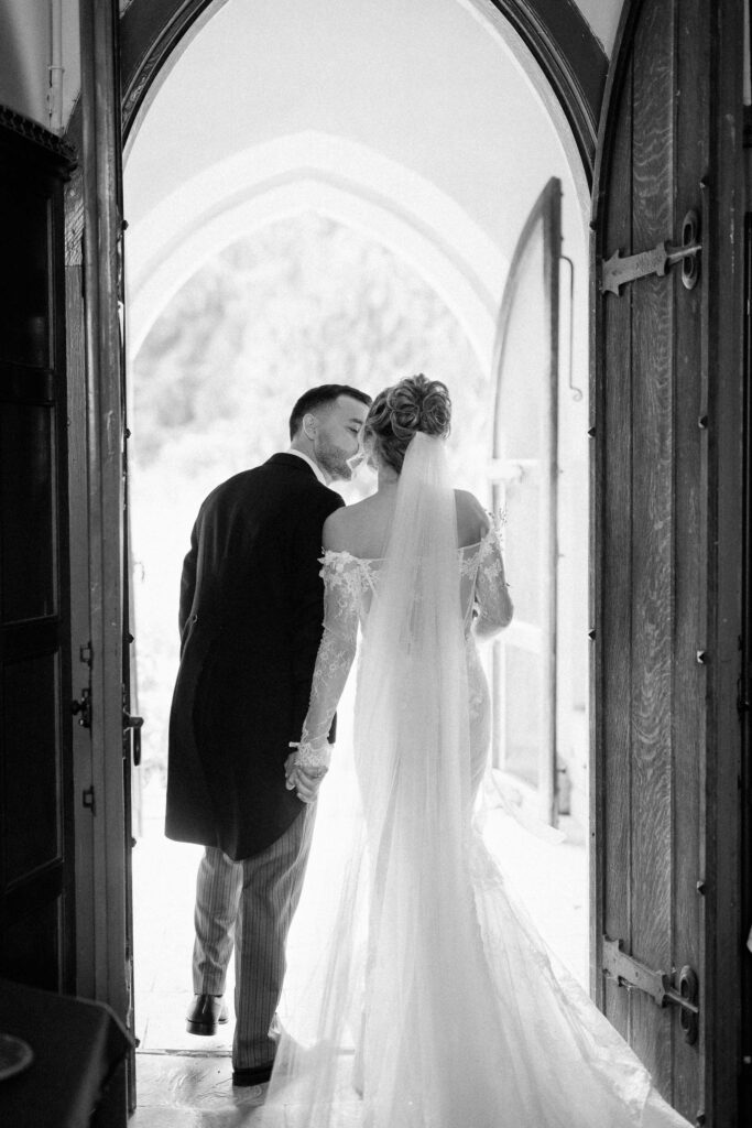 bride and groom sharing a kiss on exiting the church