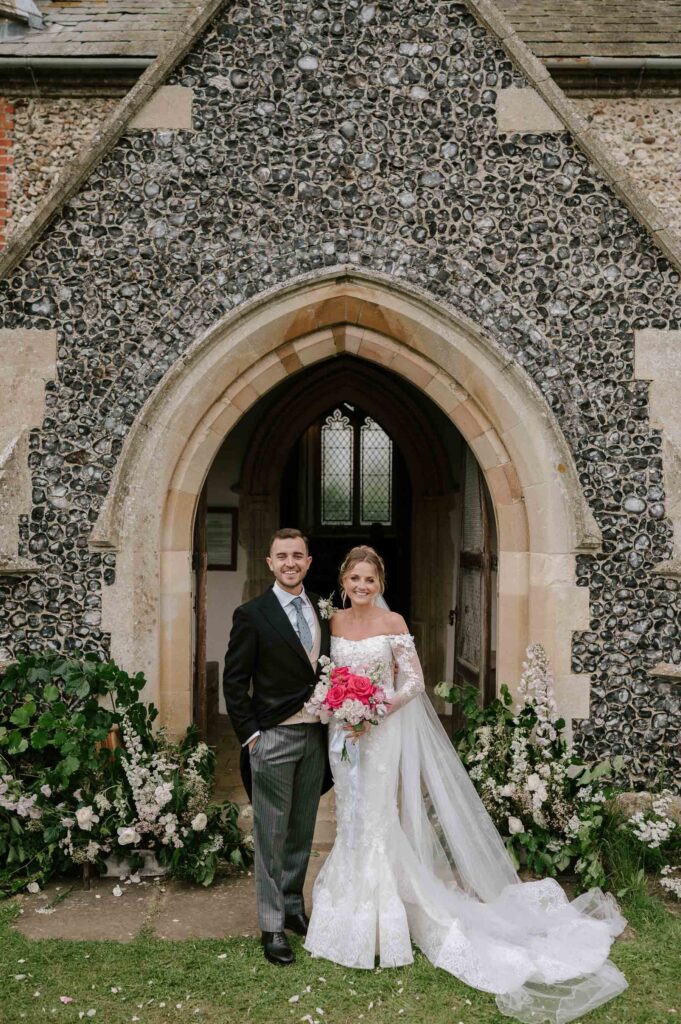 Bride and groom standing together in the church doorway after the ceremony