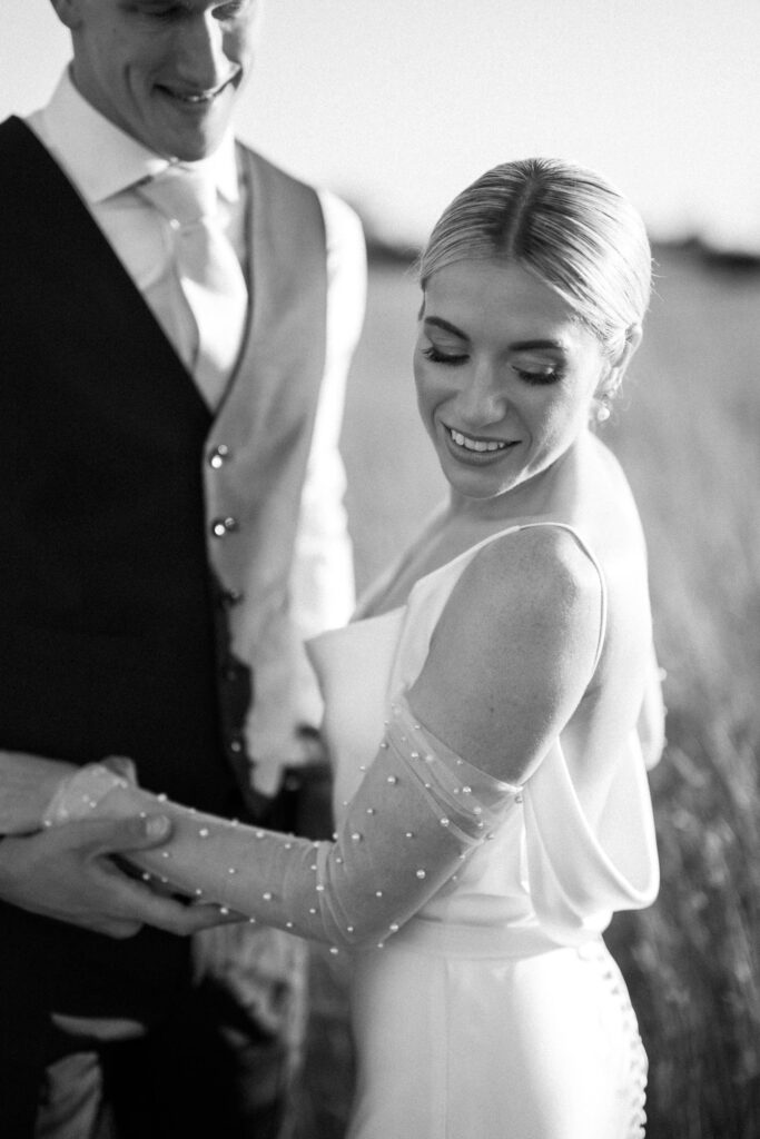 Black and white portrait of bride smiling during countryside portraits
