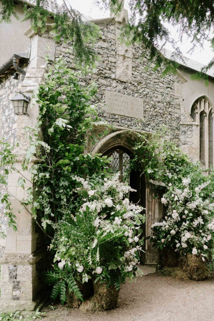 big floral installation outside church doors of earl soham church