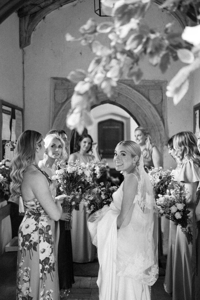 bridesmaids gathered around the bride outside the church after the ceremon