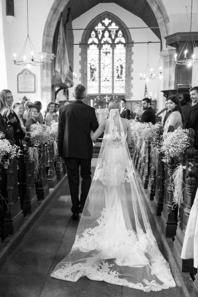 Bride walking down the aisle with her father at the church ceremony