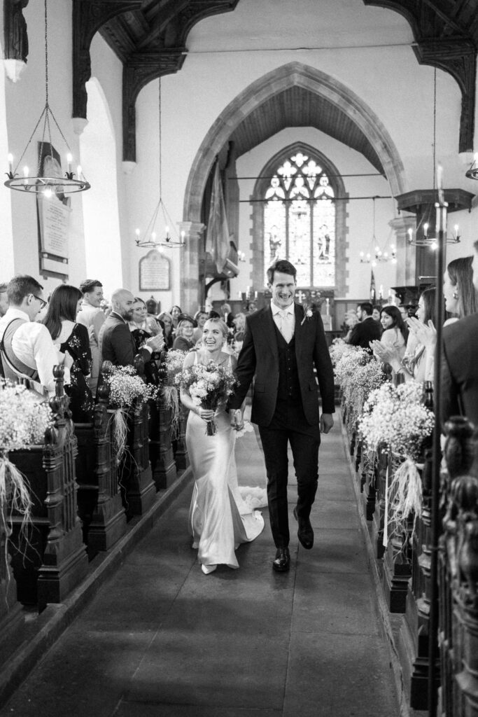 Bride and groom walking back down the aisle after the ceremony