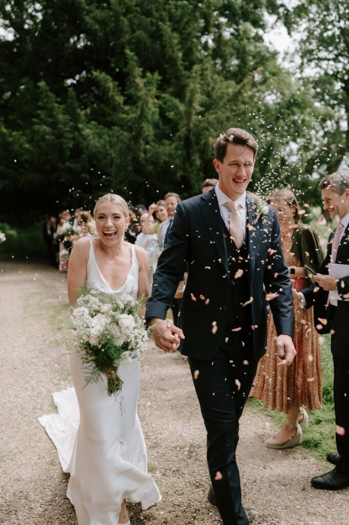 Bride and groom walking out of the church together after their ceremony