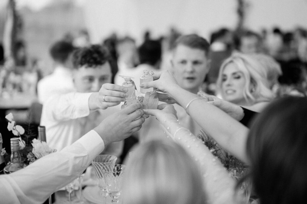 group of table cheering during wedding speeches