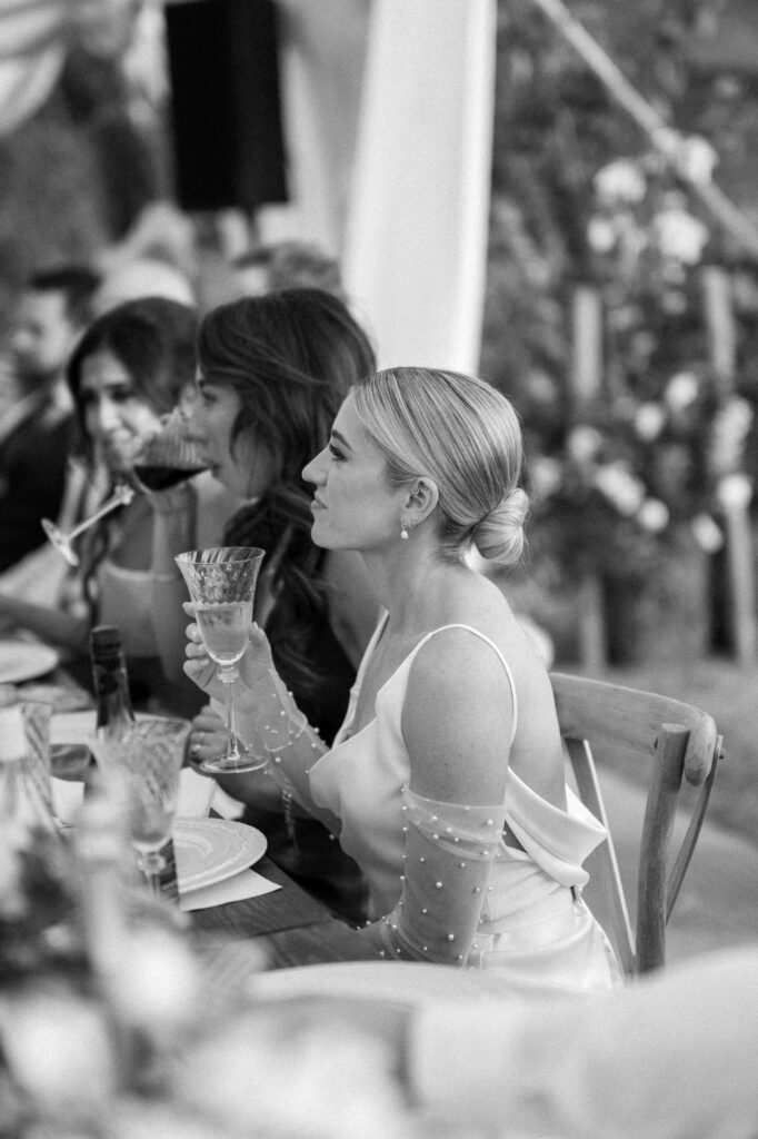Bride listening to speeches during the marquee wedding reception