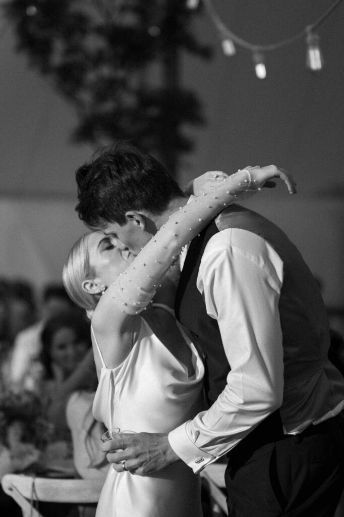 bride and groom sharing a kiss outside marquee at suffolk wedding