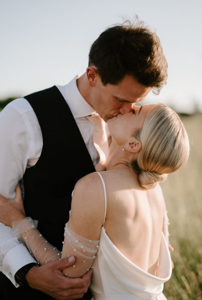 bride and groom sharing kiss at golden hour